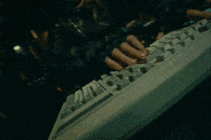 a close up of a person typing on a keyboard with a few keys missing