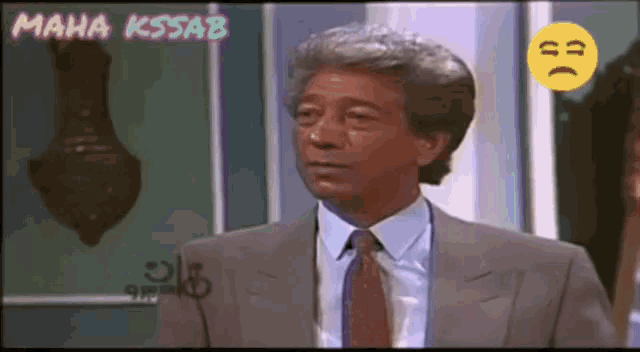 a man in a suit and tie with a smiley face next to him and the name maha kssab on the bottom