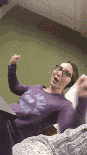 a woman wearing a purple shirt that says ' i love you '