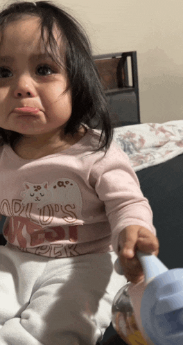 a little girl wearing a pink shirt that says adults first