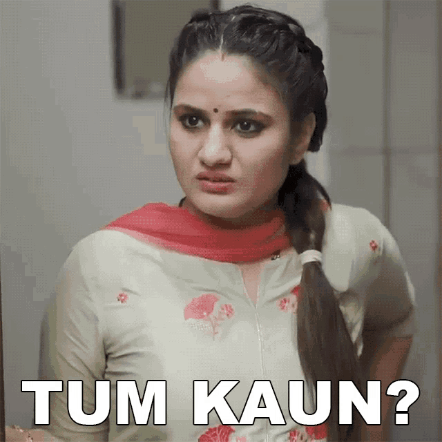 a woman is looking at herself in a mirror with the words tum kaun written below her