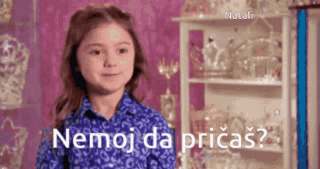 a little girl in a blue shirt says " nemoj da pricas " in a foreign language