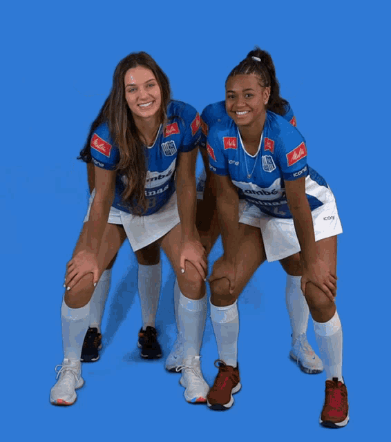 four female athletes are posing for a picture and one of them is wearing a shirt that says ' rbs '