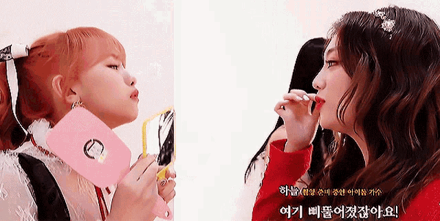 two girls are looking at each other in a mirror with korean writing