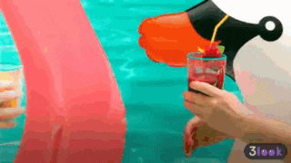 a person pouring a drink into a glass with a cherry on top