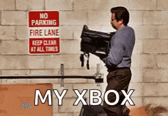a man is carrying a camera in front of a no parking fire lane sign
