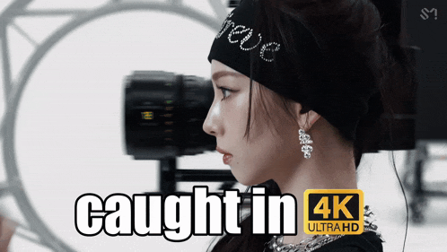 a woman wearing a headband and earrings is being photographed in 4k ultra hd