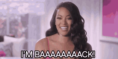 a woman in a red bra is smiling and says `` i 'm baaaaaack '' .