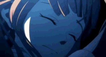 a close up of a girl sleeping with her eyes closed in the dark .