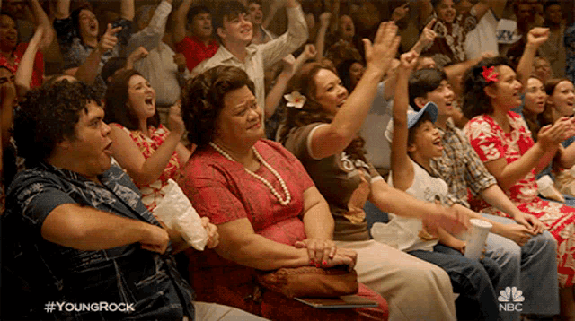 a crowd of people are watching a show called young rock on nbc