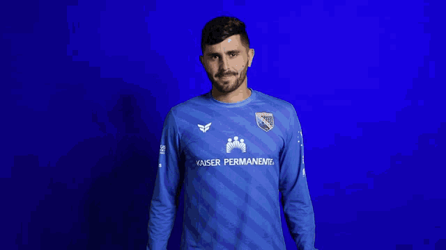 a man wearing a blue kaiser permanente shirt