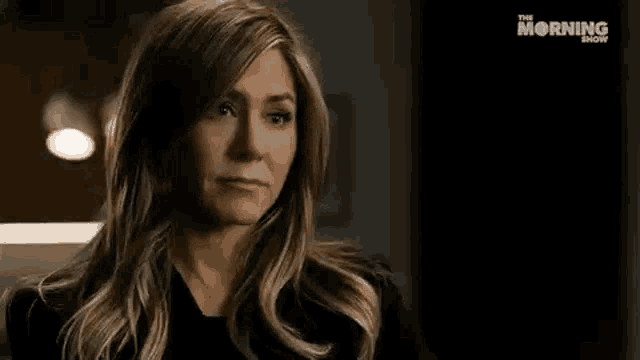 a woman is saying `` try me '' while standing in a dark room .
