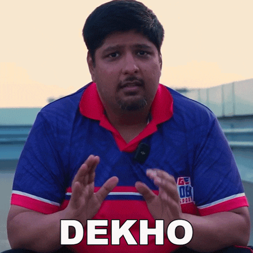 a man wearing a blue and red shirt with the word dekho written on it
