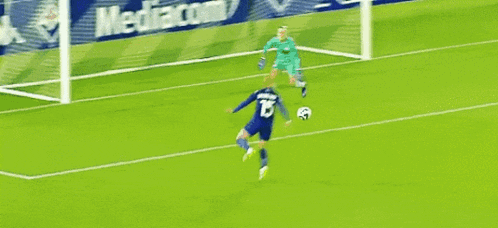 a soccer player in a blue jersey with the number 8 on it
