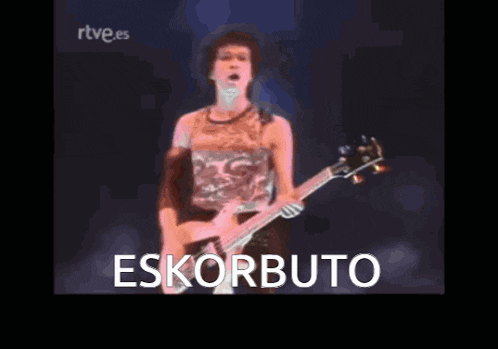 a man playing a guitar with the word eskurbuto in the corner