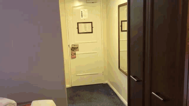 a hotel room with a door that has a sign on it that says ' emergency exit '