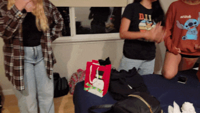 a girl wearing a shirt that says disney is standing next to another girl