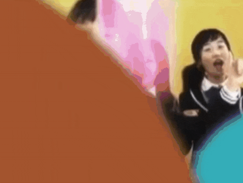 a group of girls in school uniforms are dancing together in a room .