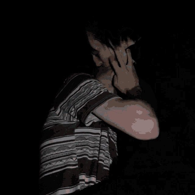 a person in a black and white striped shirt is laying down