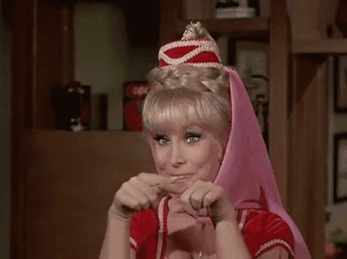 a woman is wearing a pink head scarf and a red top .