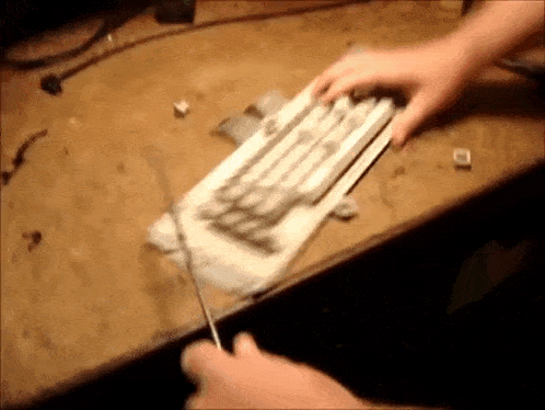 a person is cutting a piece of paper with a pair of scissors .
