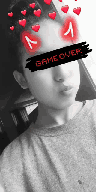 a person with hearts on their eyes and a game over sign on their face