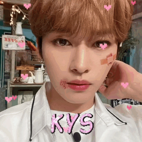 a close up of a person 's face with the word kys written in pink