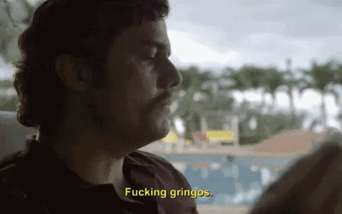 a man with a mustache is sitting in front of a pool and says " fucking gringos "