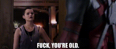 deadpool is talking to a woman in a car and saying `` fuck you 're old '' .