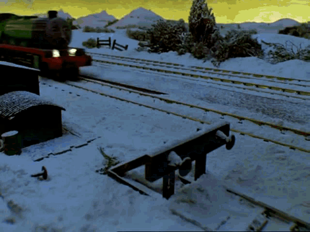 a train is on the tracks in the snow