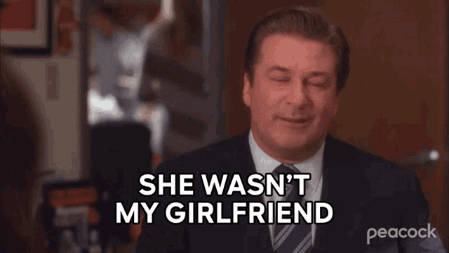 a man in a suit says she wasn 't my girlfriend