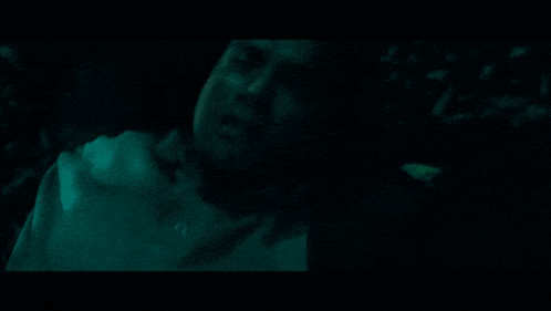 a close up of a person in a dark room