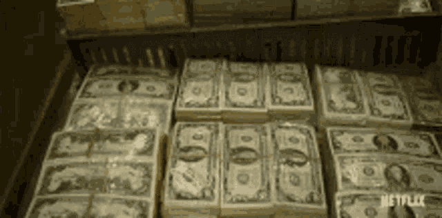 a bunch of stacks of money sitting on top of each other on a table .