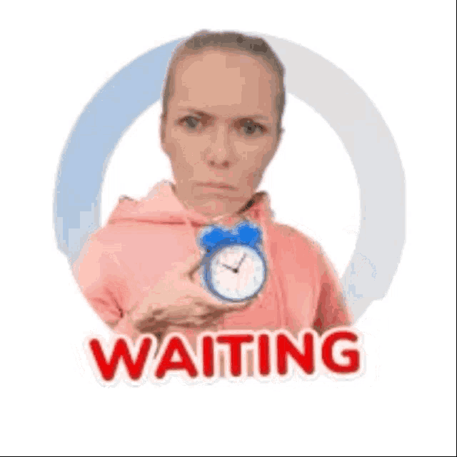 a woman in a pink hoodie is holding an alarm clock and the word waiting is on the sticker .