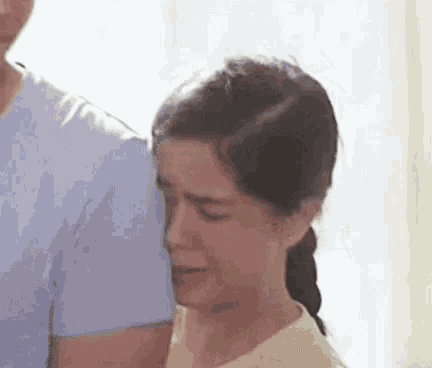 a woman is crying while being comforted by a man .