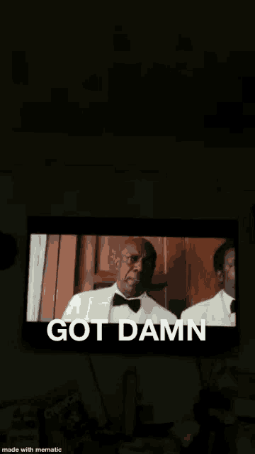 a tv screen shows a man in a tuxedo and the words got damn below him
