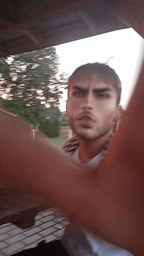a man taking a picture of himself with a blurred background