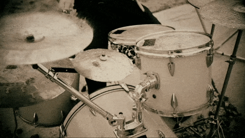 a person is playing a drum set with a cymbal that says ' a ' on it