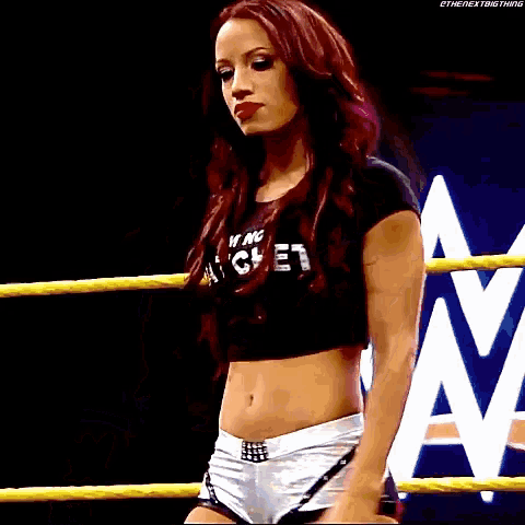 a woman in a wrestling ring wearing a shirt that says i 'm a g.e.t.