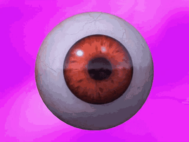 a close up of a red eye on a purple background