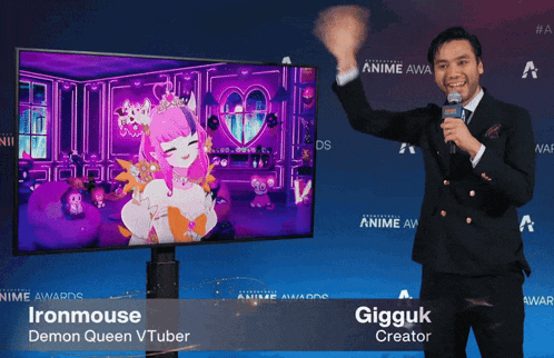 a man in a suit stands in front of a tv screen that says ironmouse demon queen vtuber on the bottom