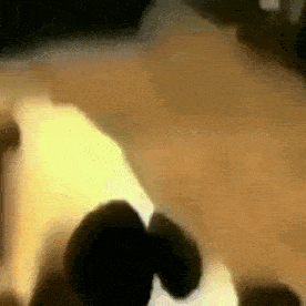 a blurry picture of a person laying on a bed with a light shining on them .