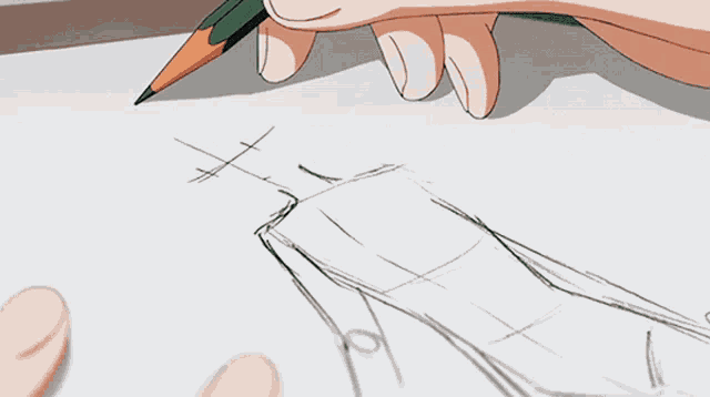 a person is drawing on a piece of paper with a book in the background