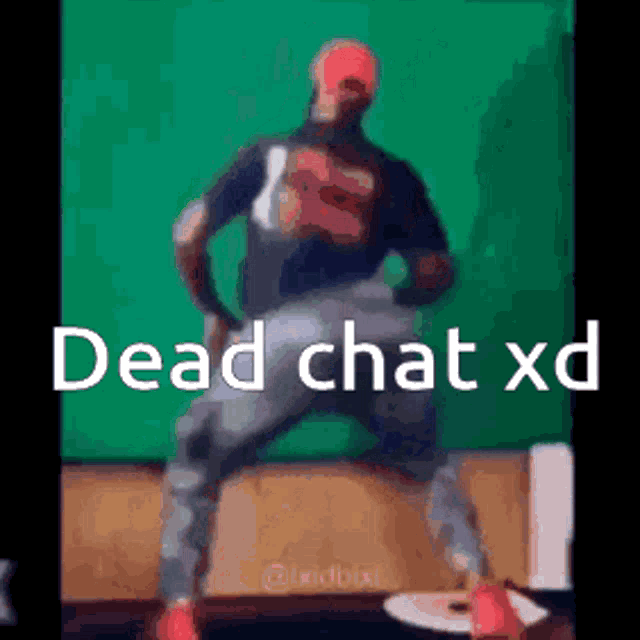 a man is dancing in front of a green screen with the words dead chat xd written on it .