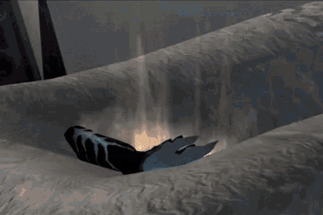 a person 's hand is reaching out in a video game scene