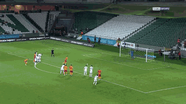 a soccer game is being played in an empty stadium with a sign that says bein sports