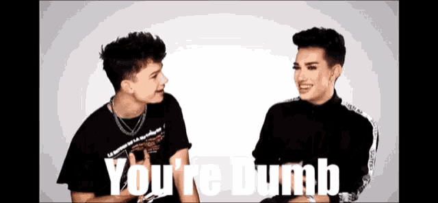two men sitting next to each other with the words you 're dumb