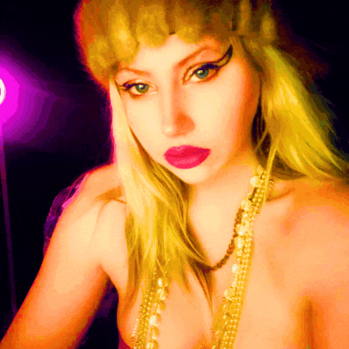 a woman with blonde hair and red lips is wearing a gold necklace and a fur hat