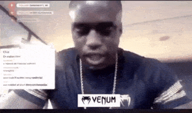 a man wearing a black shirt with venum written on the front