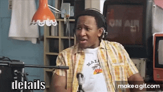 a man in a plaid shirt is talking into a microphone with the words details written below him